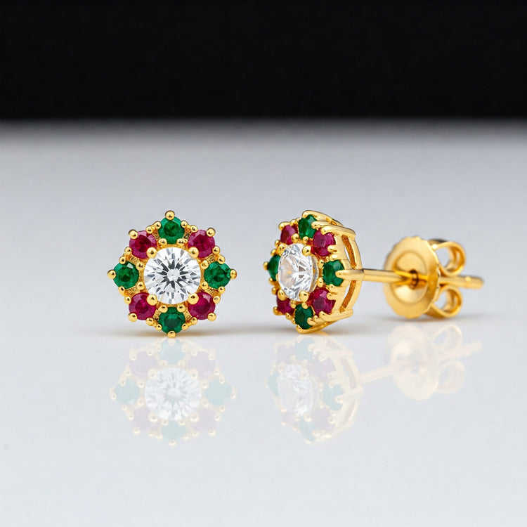 Pair of sparkling Feelori AD Stone stud earrings with ruby and emerald colored accents - vibrant Indian jewelry.