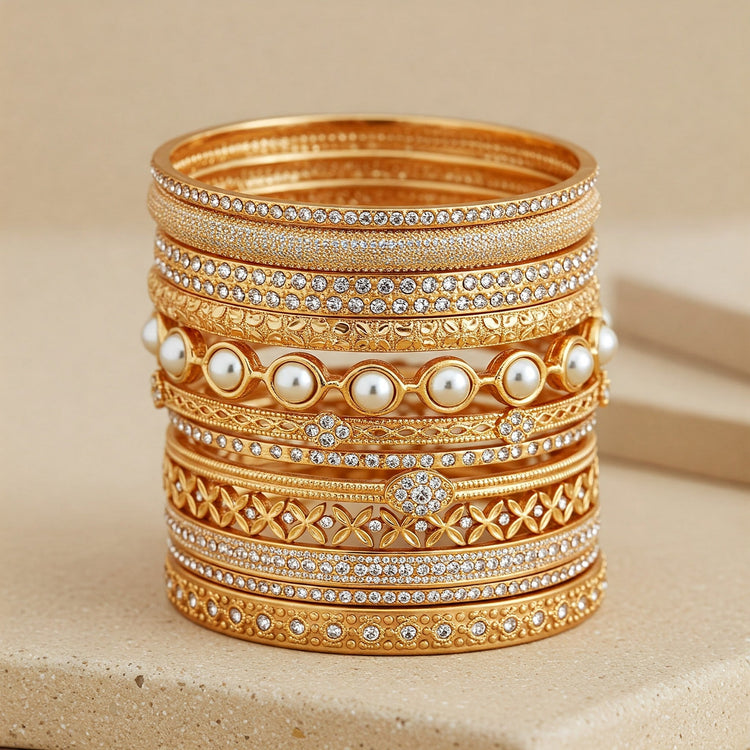 Artful stack of diverse Feelori bangles showcasing mixed styles (gold plate, CZ accent, pearl, Kada hint) - versatile Indian jewelry collection.