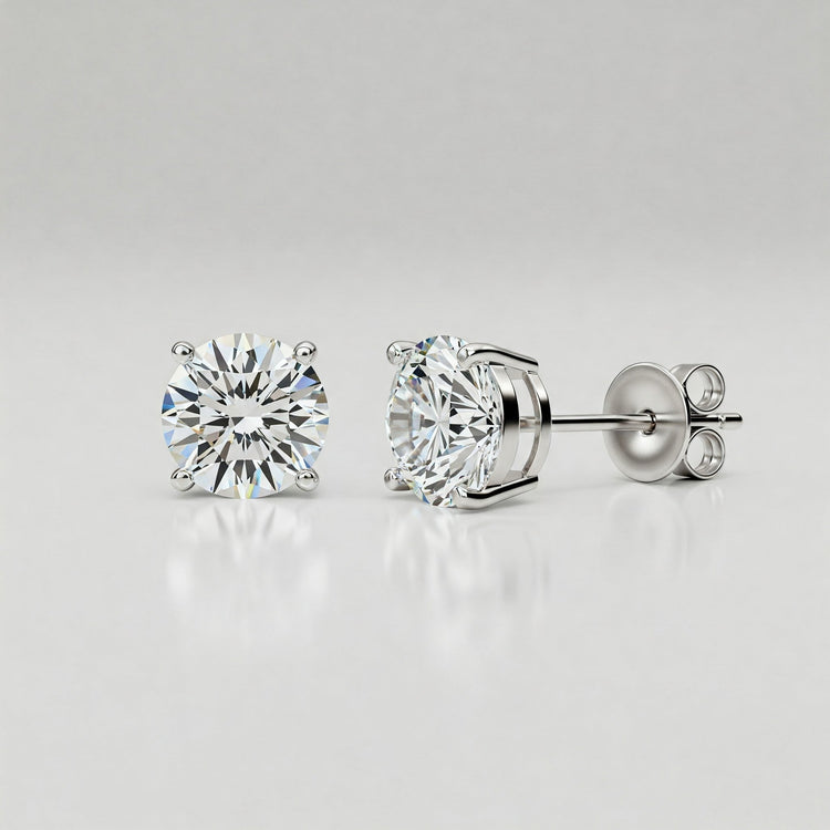 Pair of classic Feelori CZ solitaire stud earrings displaying brilliant sparkle in a simple setting - essential Indian jewelry.