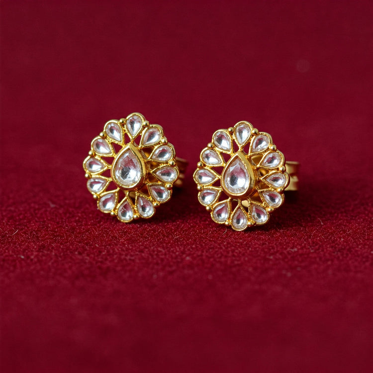 Pair of intricate Feelori Jadau Kundan stud earrings in traditional gold setting - luxury Indian jewelry.