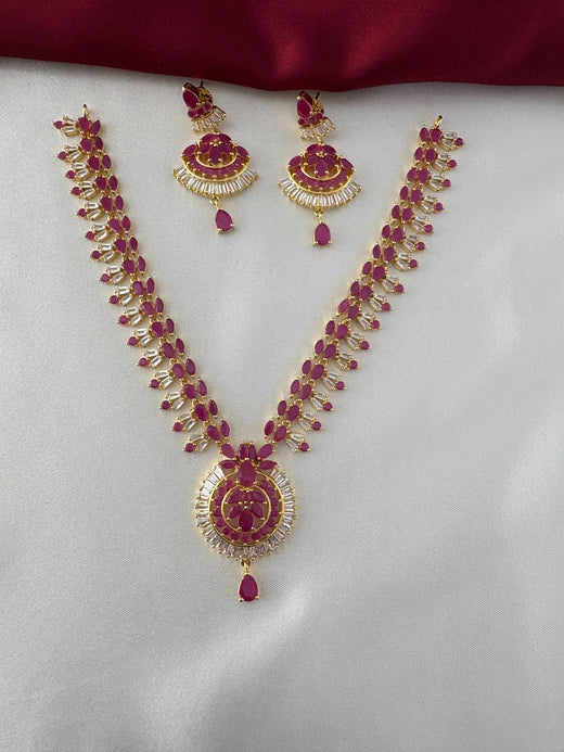 FeelOri Gold Plated Ruby & CZ Necklace Set - Full view showcasing the ornate necklace with its prominent central pendant and matching earrings.