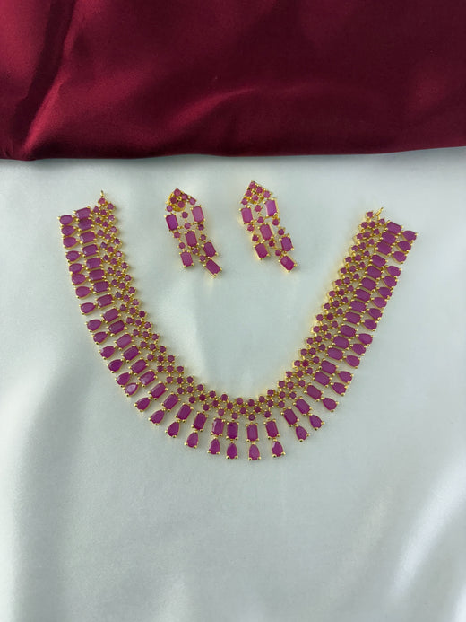FeelOri Gold Plated Ruby Drop Kundan Necklace Set - Front view showcasing the complete set with interconnected ruby-hued stones.