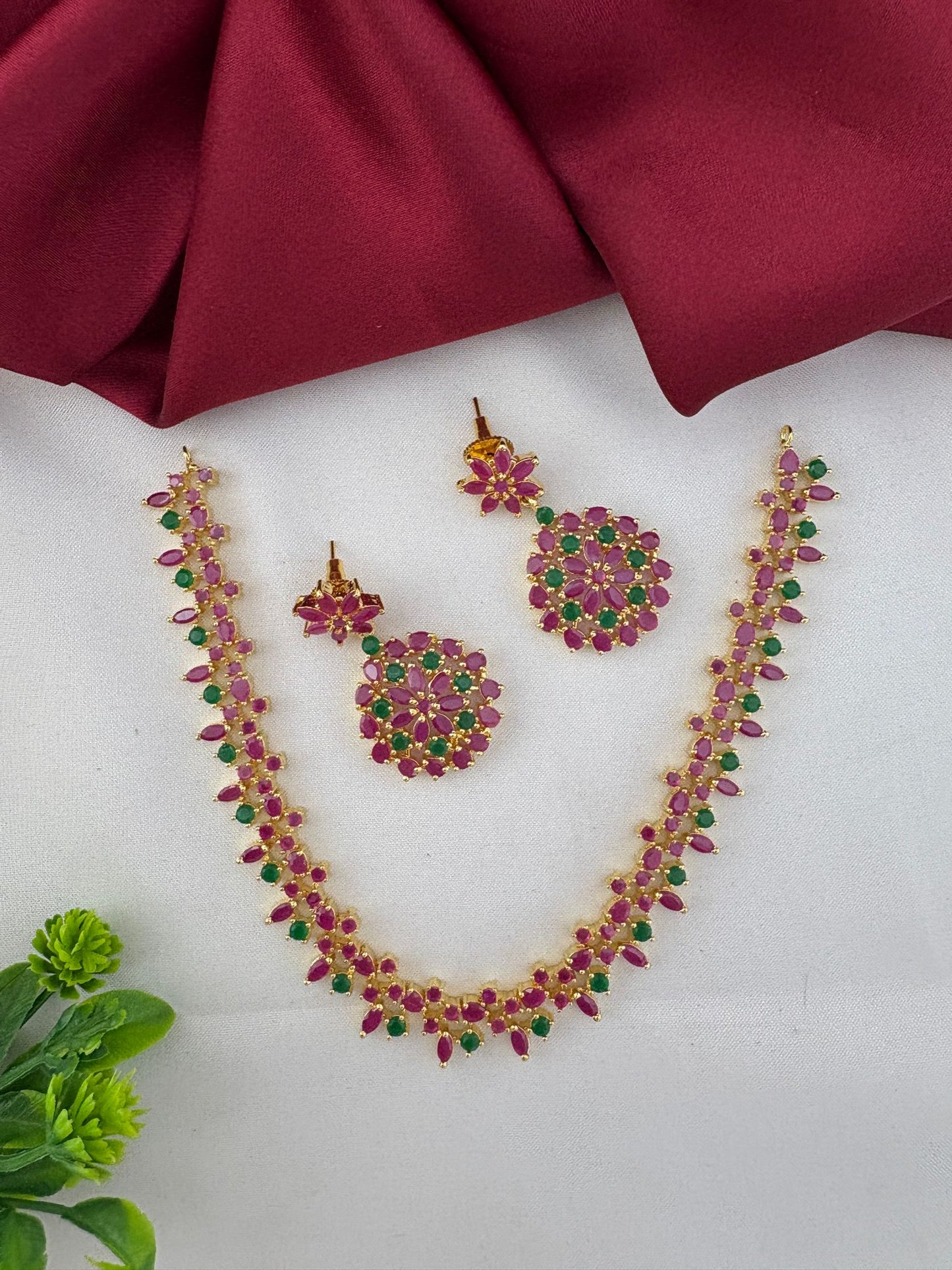 FeelOri Andhra Festive Gem Ruby & Emerald Short Necklace Set - Full set displayed with necklace and earrings, styled with a subtle green accent.