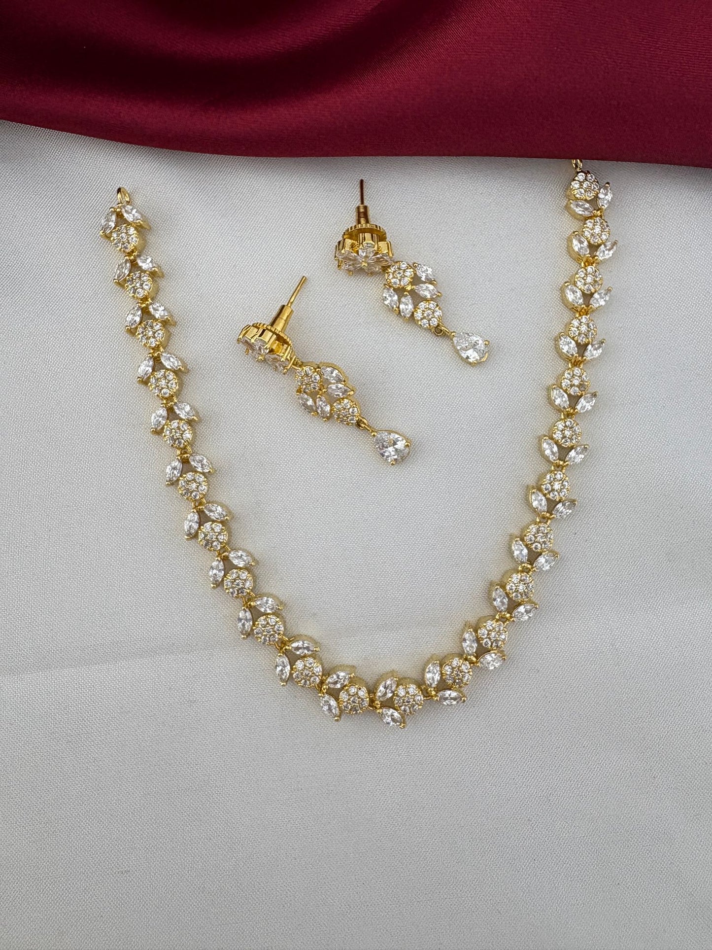 FeelOri Bollywood Glam AD Stone Statement Choker Set - elegant gold-tone necklace and drop earrings with sparkling AD stones.