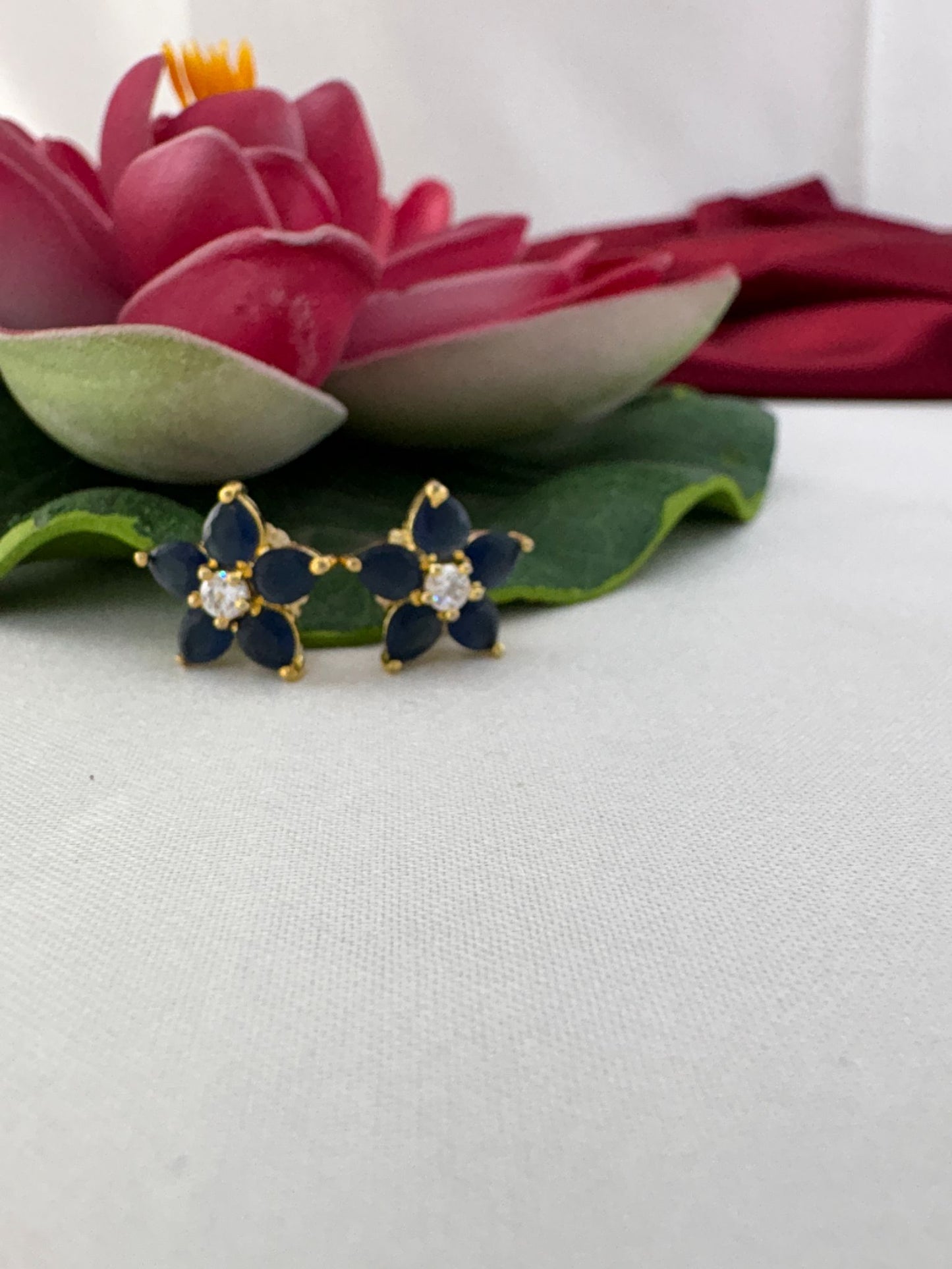 FeelOri classic blue sapphire AD stud earrings styled with pink lotus creating royal sophisticated color contrast