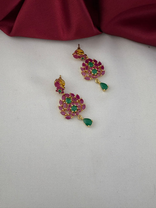 Detailed close-up of FeelOri Classic Duo Ruby & Emerald Earrings, showcasing ruby and emerald stones and gold-tone finish.