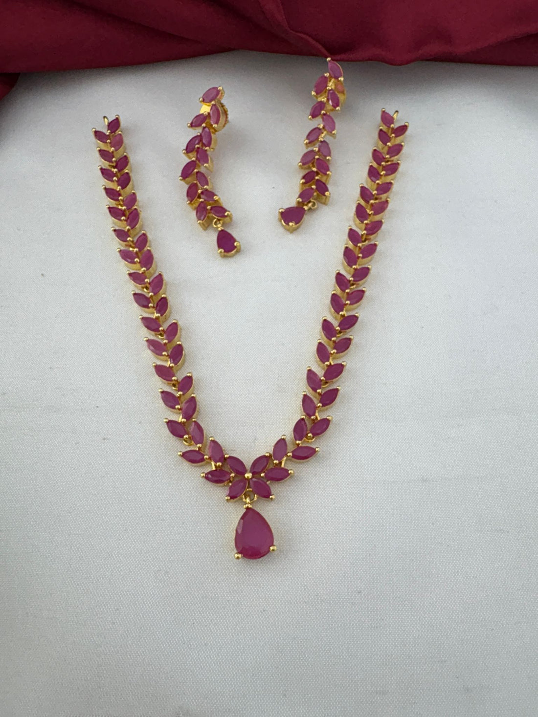 Clear view of FeelOri's Elegant Ruby-Tone CZ Short Necklace Set with matching earrings. Gold plated finish, ideal for Bangalore events.