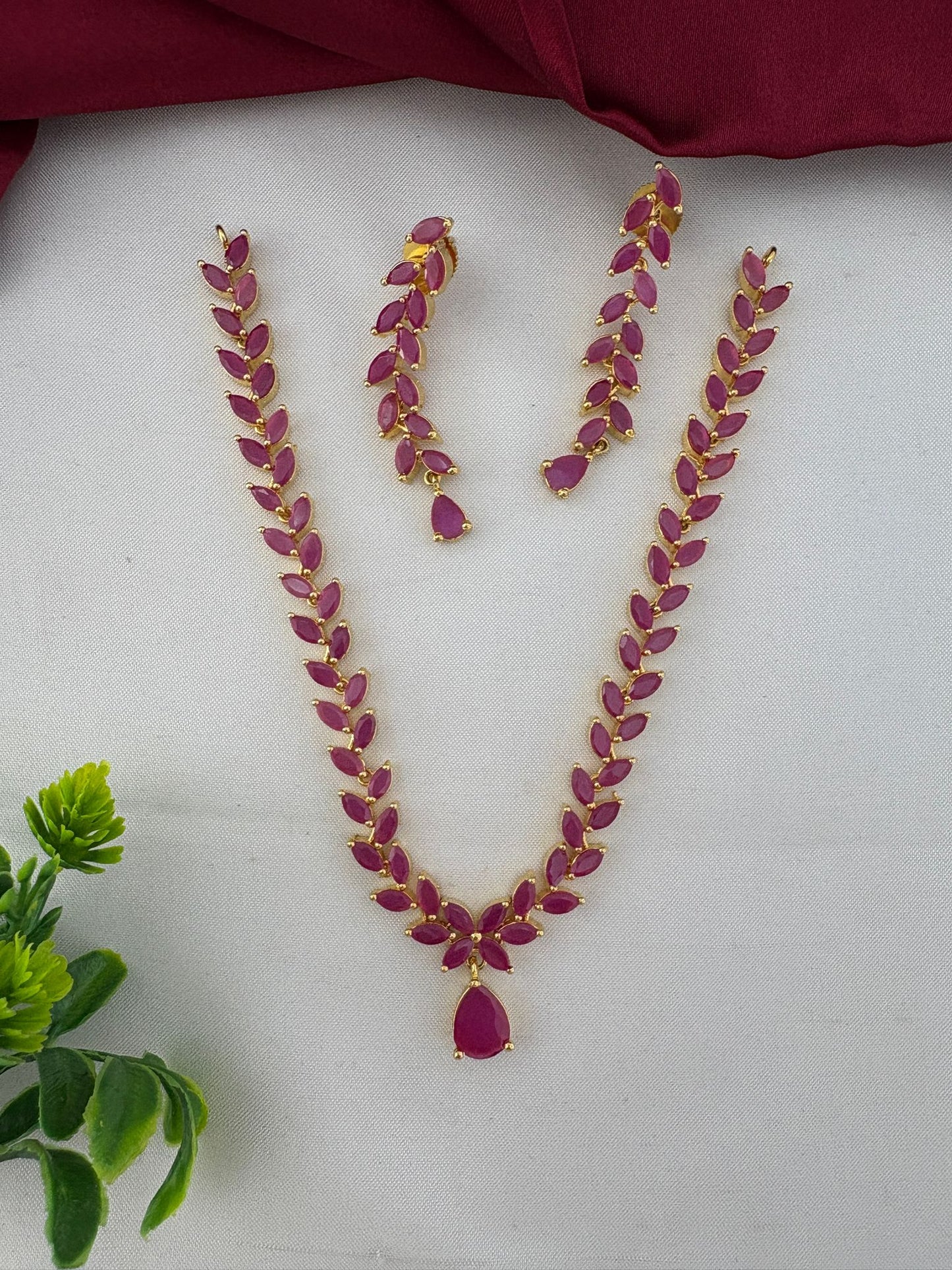 FeelOri Elegant Original Ruby Short Necklace and Earrings Set, styled with decorative element, perfect for Bangalore events. Gold plated design with vibrant ruby stones.