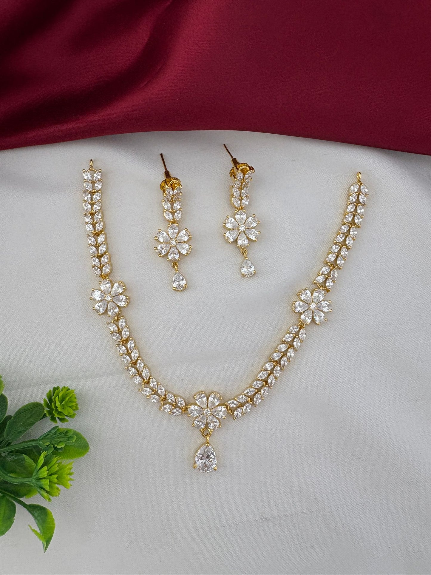 FeelOri Everyday Elegance AD Stone Pendant Short Necklace and Earrings Set - Full view on white and maroon fabric