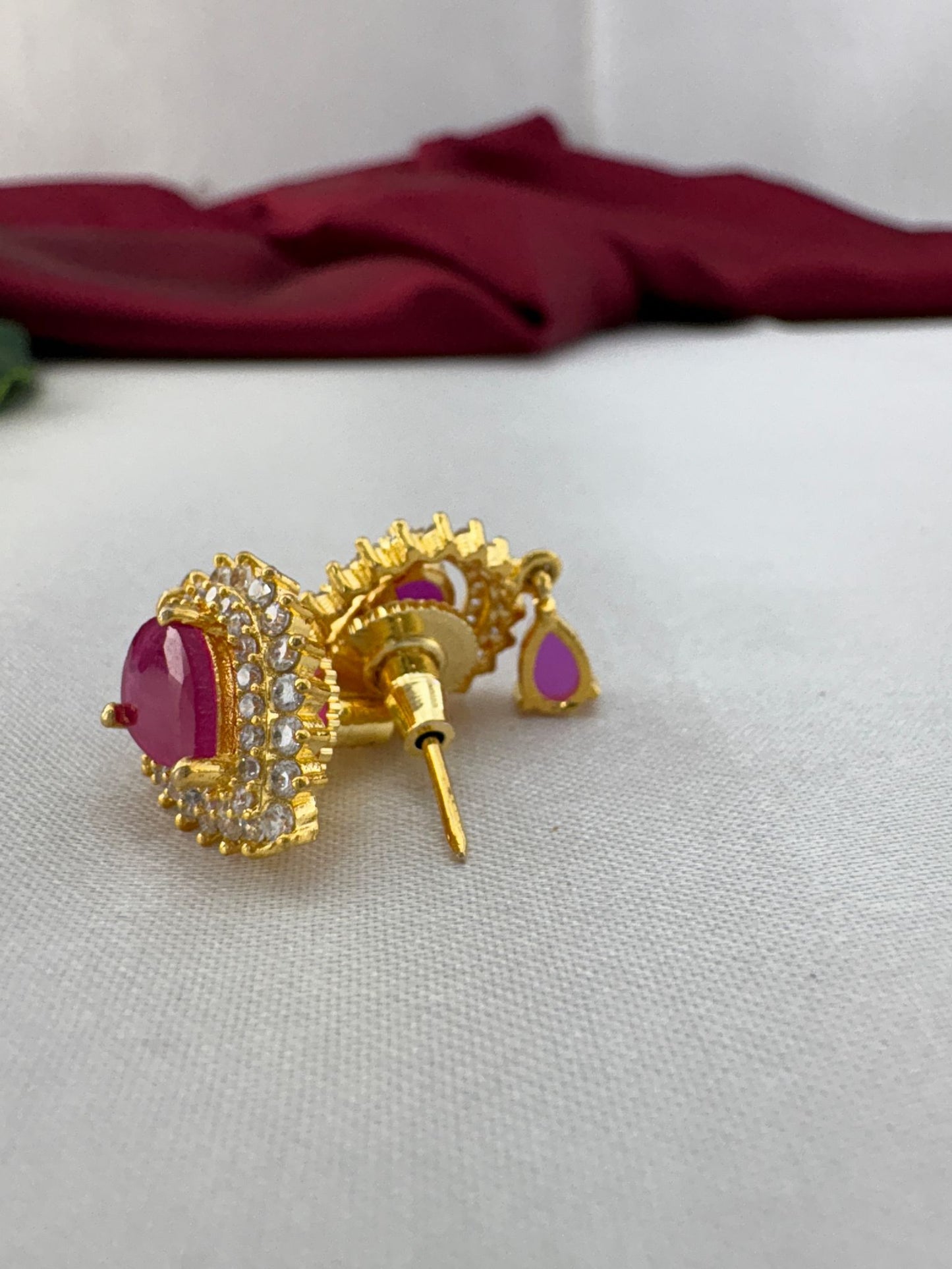 FeelOri Fuchsia Flash bright pink AD stud earrings angled view displaying gold post mechanism and secure back