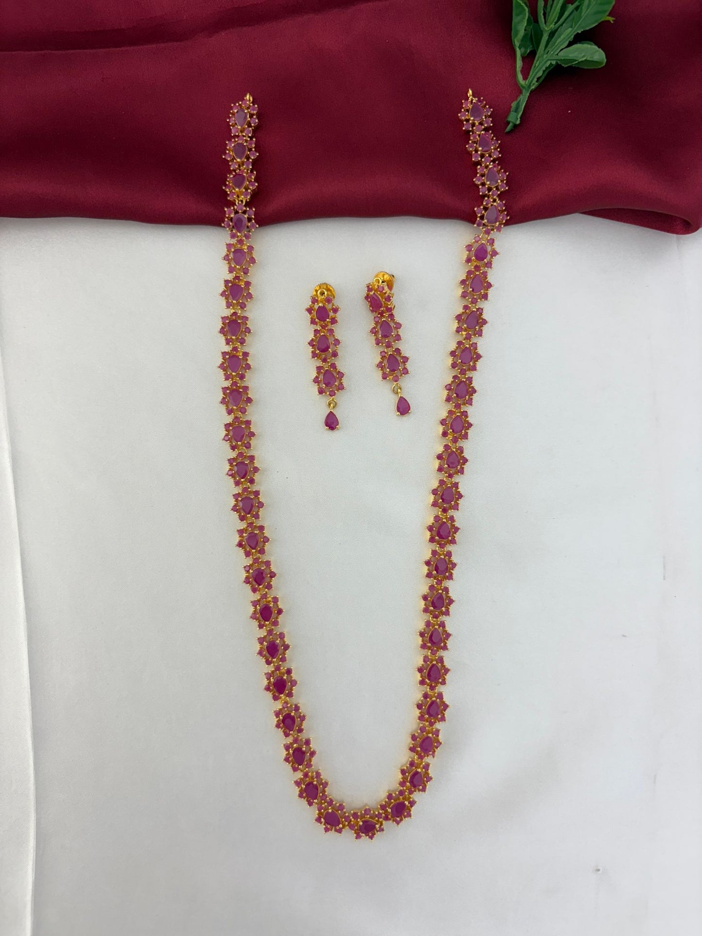 FeelOri Geometric Glow Ruby Station Long Necklace & Earring Set - Full view of the ruby necklace and matching earrings laid flat.