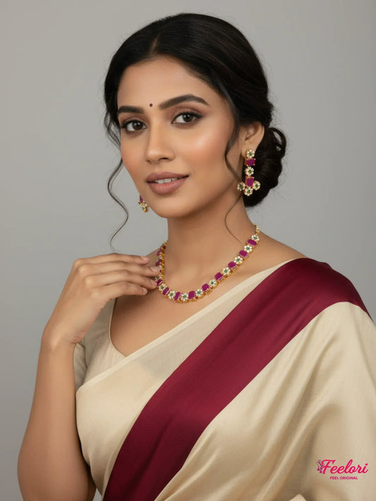 FeelOri Gold Plated Ruby Emerald Floral Necklace Set - Model wearing set with traditional saree, smiling at camera.