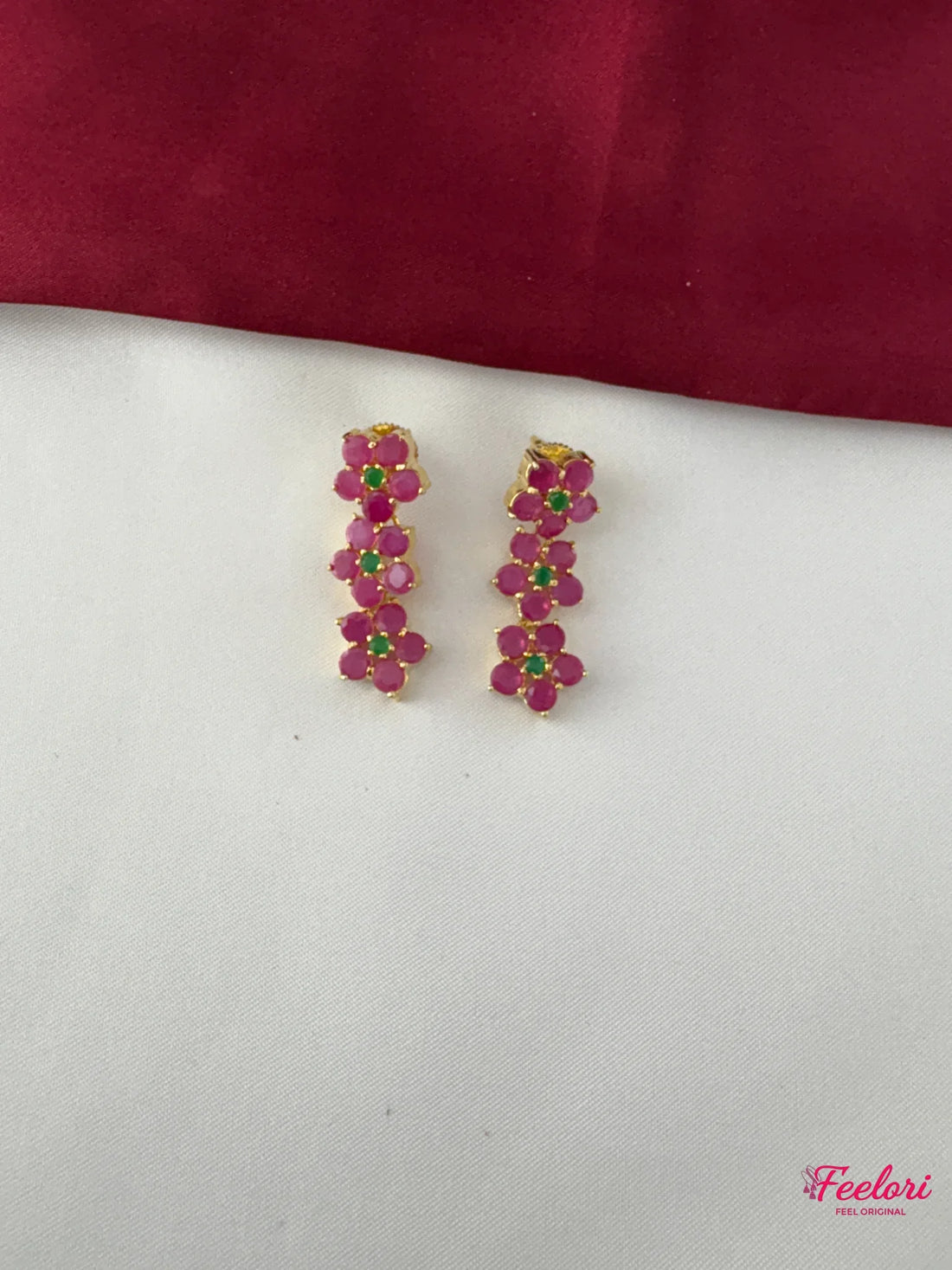 FeelOri Gold Plated Ruby Emerald Flower Cluster Earrings - Close-up view showing the delicate ruby petals and Emerald center of the matching earrings.