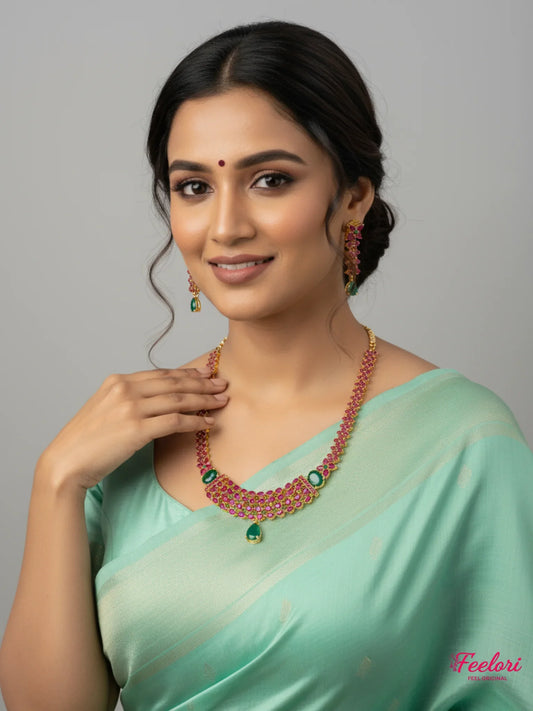 FeelOri Gold Plated Ruby Emerald Layered Necklace Set - Model wearing radiant set with light green Indian saree.