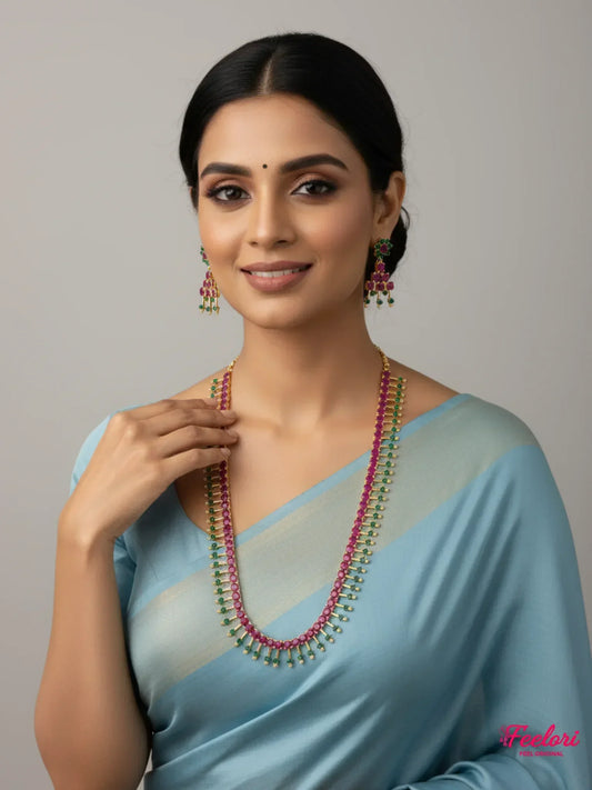 FeelOri Gold Plated Ruby Emerald Necklace Set - Model in light blue saree wearing layered petal design.