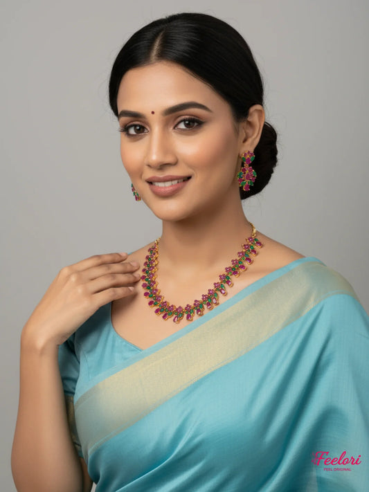 FeelOri Ruby Emerald Necklace Set - Model wearing floral cluster jewelry with blue traditional saree
