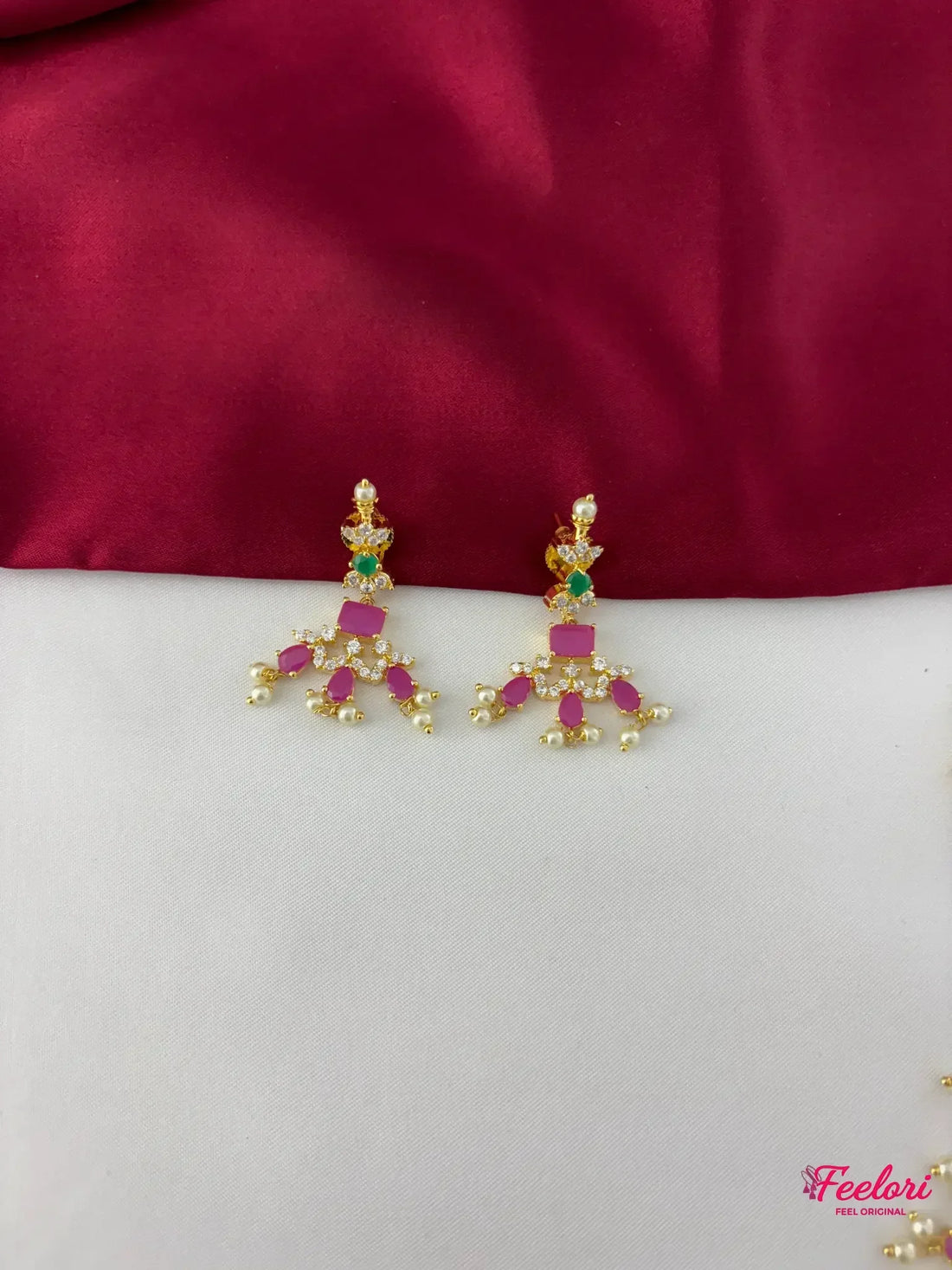 FeelOri Gold Plated Ruby Emerald Pearl Haaram Earrings - Close-up view of the intricate earrings, highlighting the Ruby-Tone CZ and emerald stones set with dangling pearls.