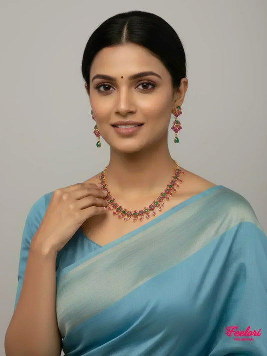 FeelOri Gold Plated Ruby Emerald Necklace Set - Model wearing elegant set with blue traditional saree