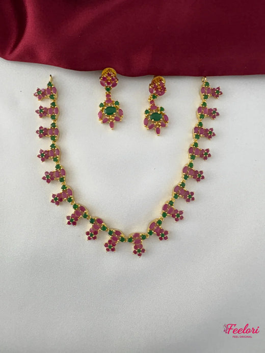 FeelOri Gold Plated Ruby Emerald Earrings - Close-up view showing the intricate vine-like arrangement of Ruby CZ and emerald stones against a rich gold plating.