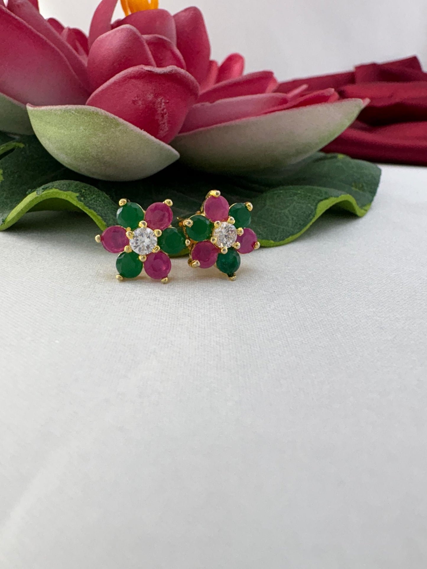 FeelOri confetti pop multi-color AD stud earrings styled with lotus showcasing party-ready festive appeal