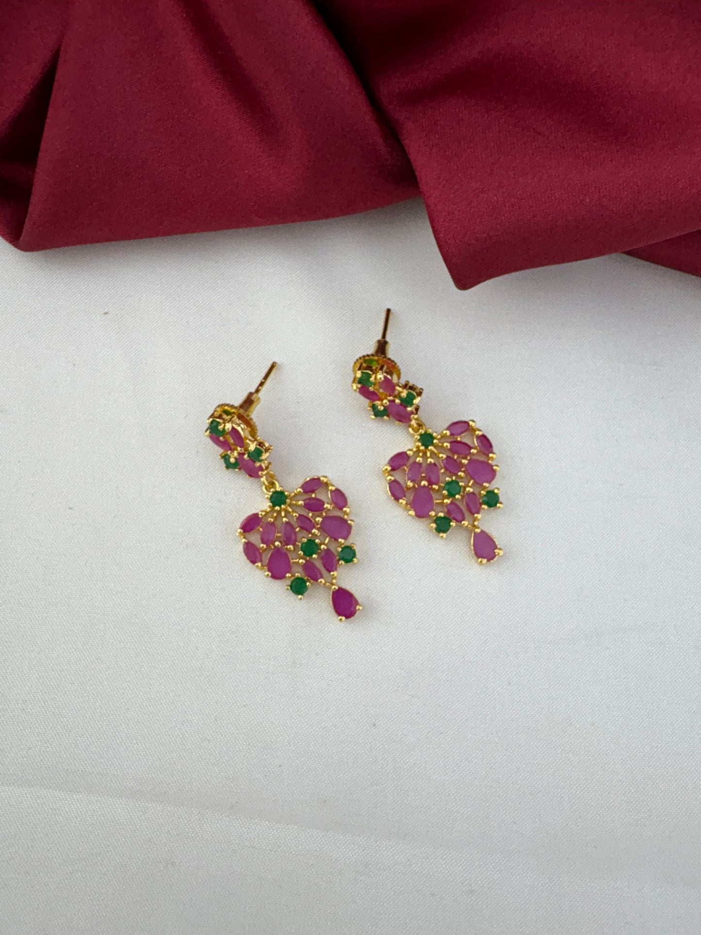 Detailed close-up of the FeelOri Mysore Vasantham ruby and emerald stone earrings, highlighting the design.