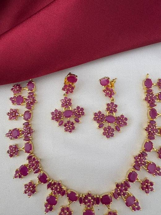 Detailed close-up of FeelOri Nakshi Work Ruby earrings and necklace. Highlights the intricate design and gemstones of the Telangana Art inspired set by feelori.