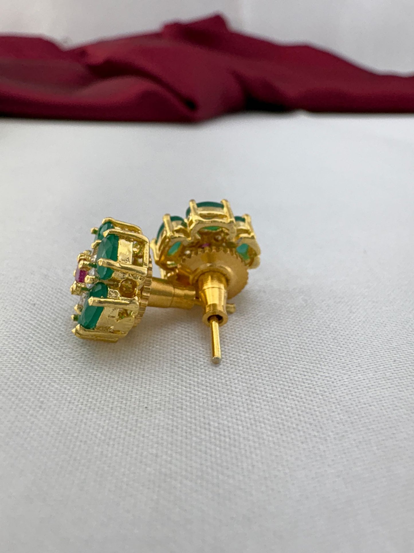 FeelOri Peridot Gleam olive green AD stud earrings angled view displaying gold post construction and back mechanism