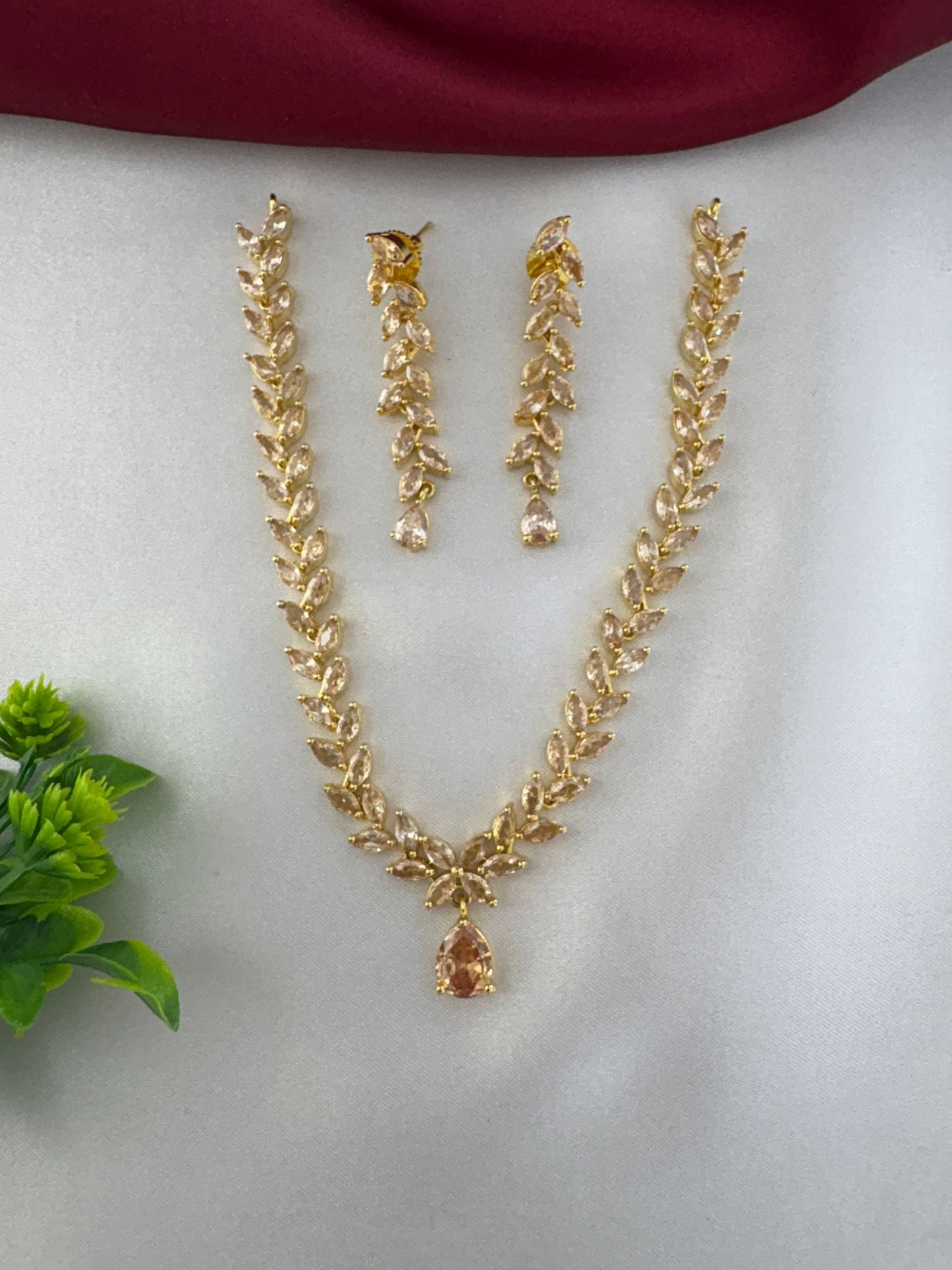 feelori Regal Gold Filigree AD Short Choker Set - Royal Touch - Full necklace and earrings set with decorative plant accent