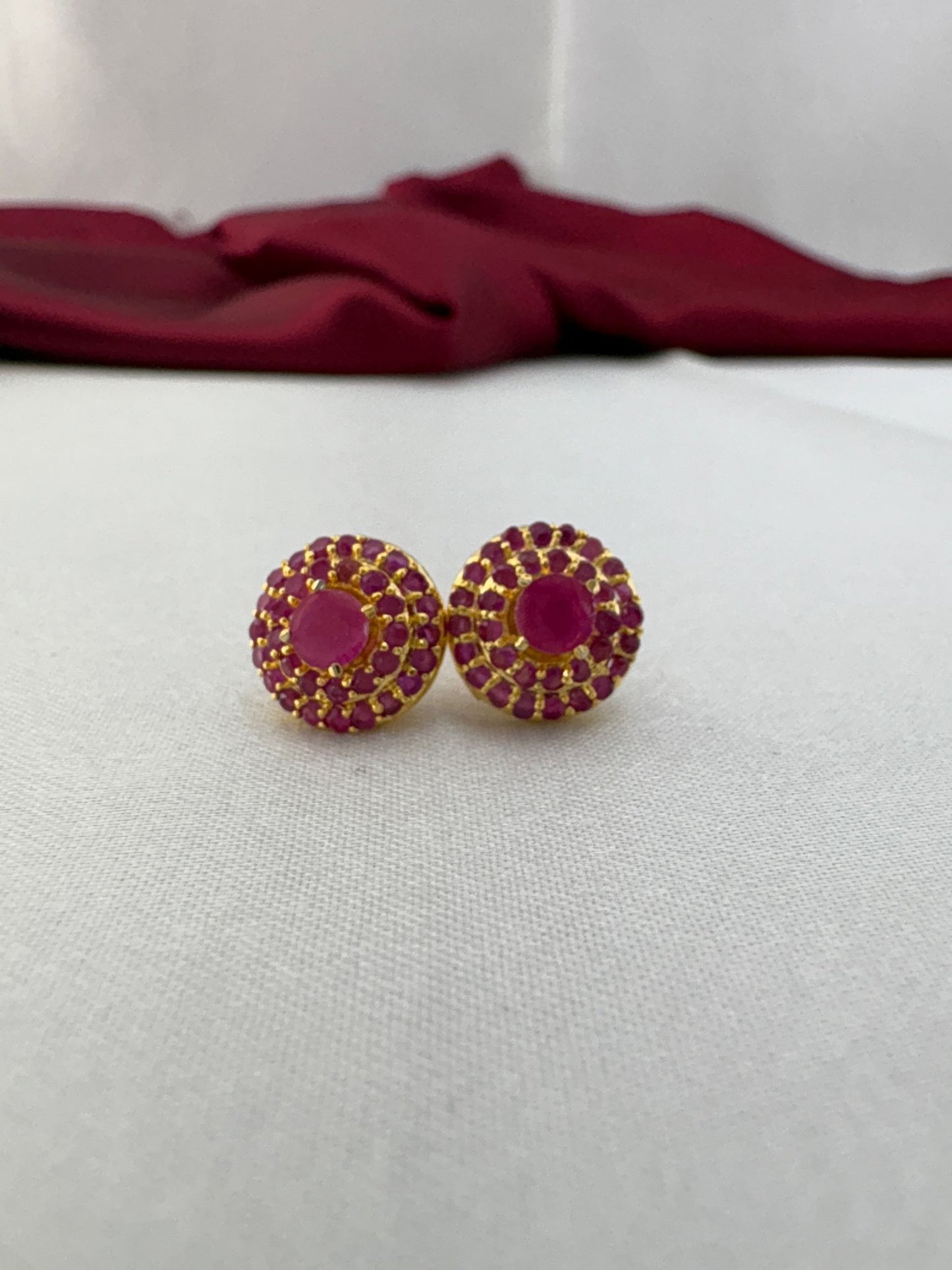 FeelOri Rose Bloom pink AD stud earrings pair on white fabric featuring romantic pink stones in floral cluster