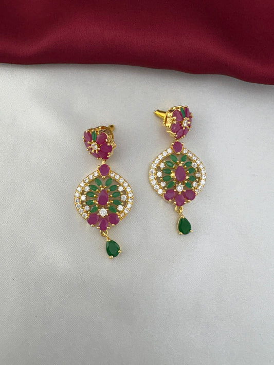 Feelori close-up of gold-plated earrings with ruby, emerald, and AD stone detailing, part of a traditional necklace set.
