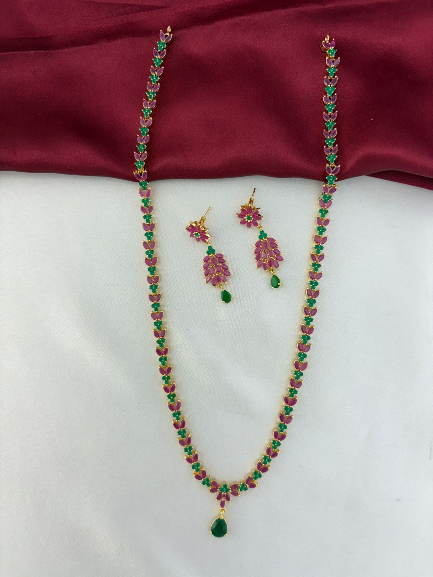 Feelorì Twin Souls Ruby & Emerald Alternating Long Necklace & Earring Set - Necklace laid out with matching earrings.