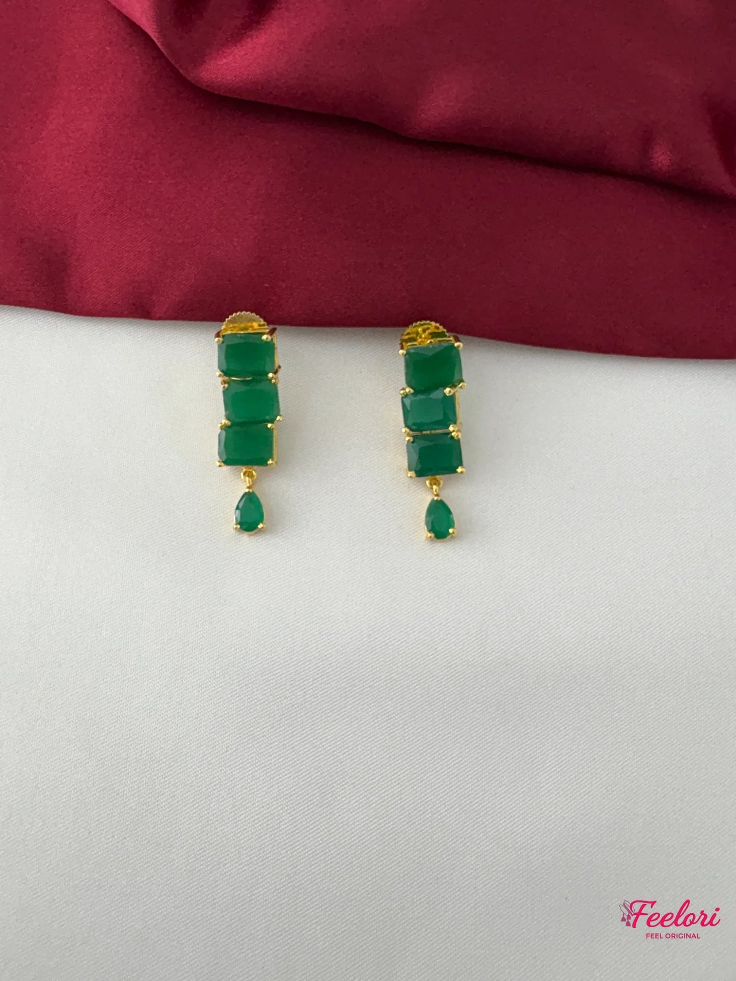 FeelOri Gold Plated Emerald Rectangle-Cut Earrings - Close-up view highlighting the stacked rectangular green stones and delicate teardrop accent.