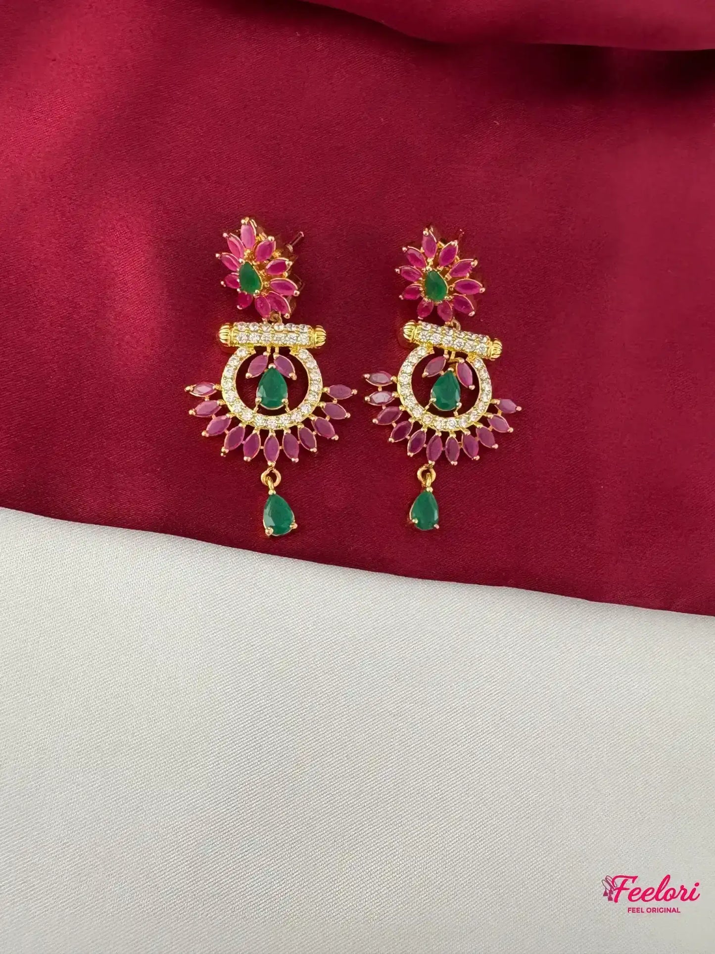 FeelOri Gold Plated Ruby & Emerald Floral Earrings - Close-up view showing the detailed flower stud, crescent dangler, and sparkling genuine CZ-like stones.