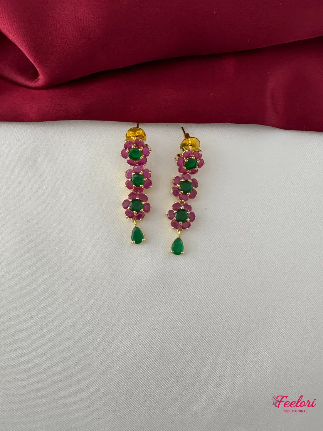 FeelOri Gold Plated Ruby Emerald Floral Petal Earrings - Close-up view of the dangle earrings, highlighting the Ruby CZ and emerald petal design and teardrop drop.