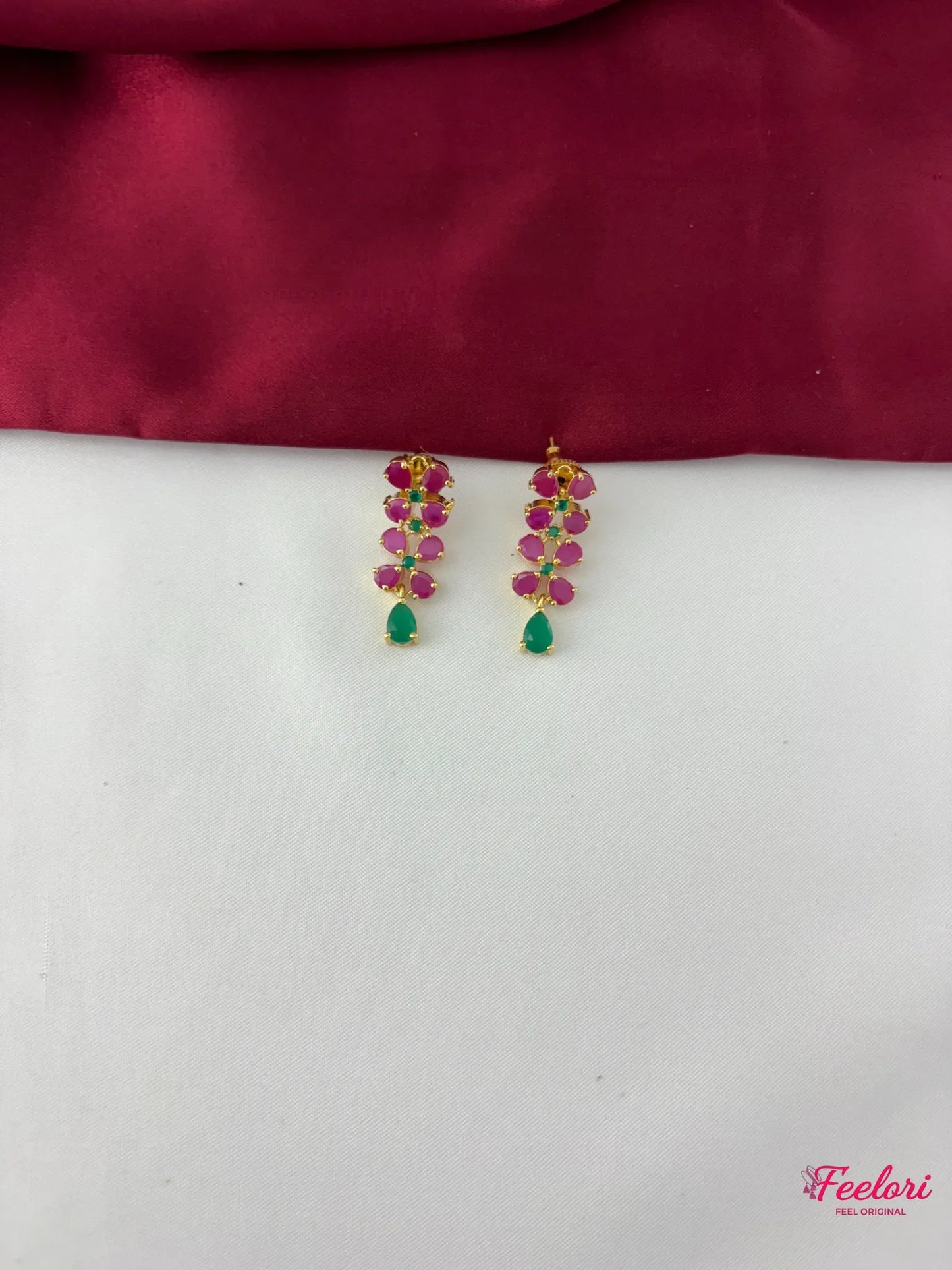 FeelOri Gold Plated Ruby Emerald Leaf Motif Earrings - Close-up view of the matching earrings featuring a graceful cluster of genuine ruby and emerald stones.