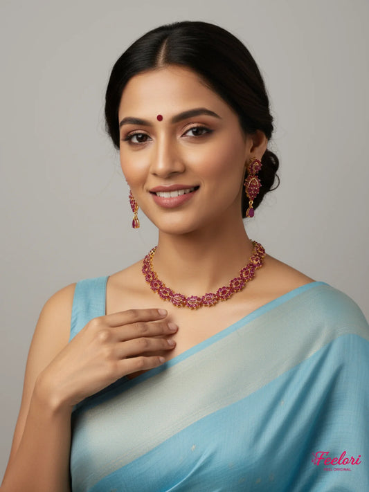 FeelOri Gold Plated Ruby Floral Necklace Set - Model in light blue saree smiling