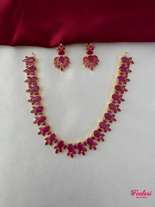 FeelOri Gold Plated Ruby Petal Necklace Set - Front view showing the complete ensemble with necklace and matching drop earrings.