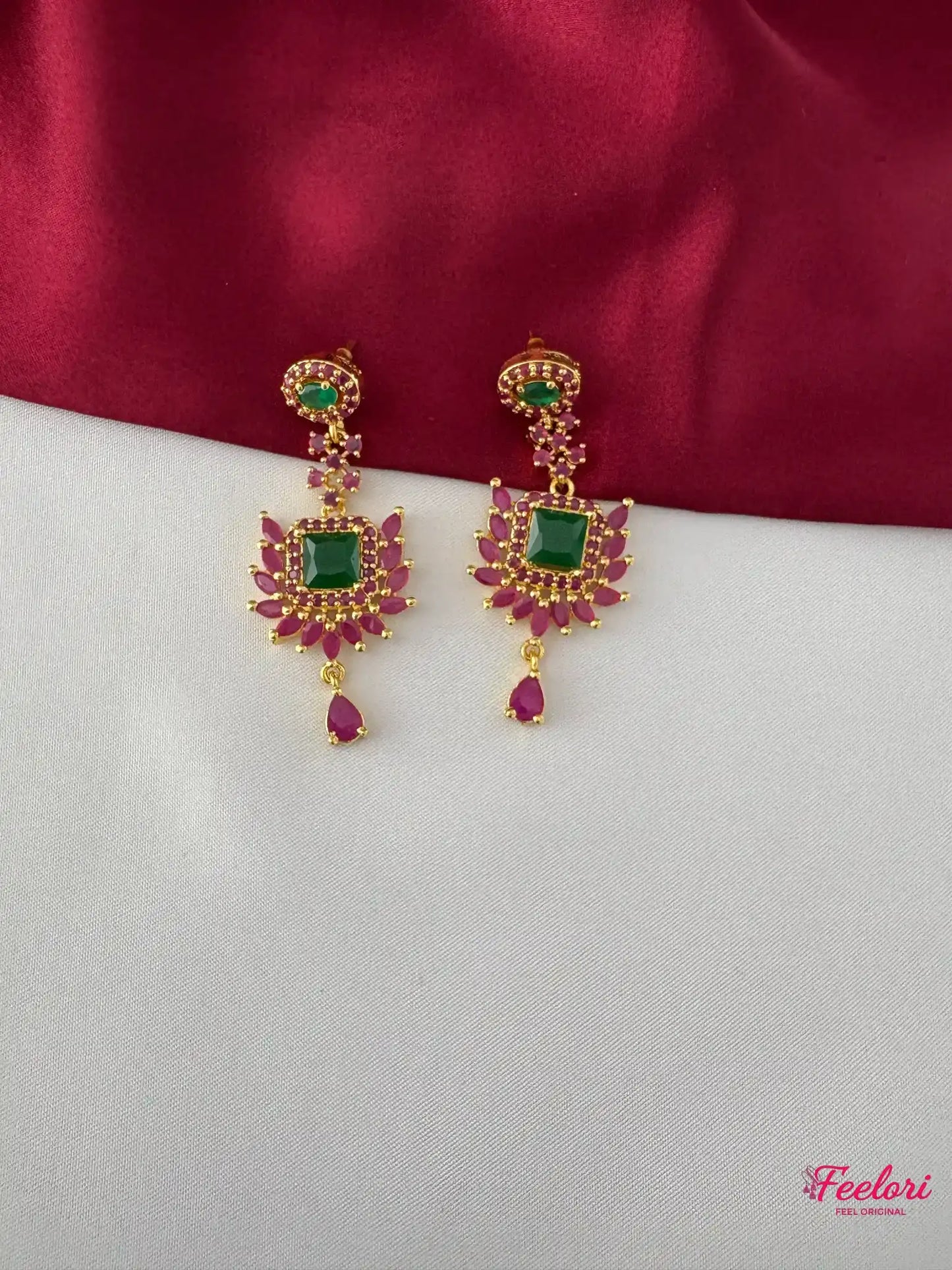 FeelOri Gold Plated Ruby Emerald Earrings - Detailed view highlighting the square emerald-hued stone and dangling ruby drops.
