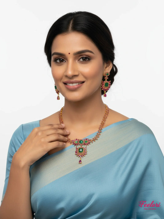 FeelOri Gold Plated Ruby Emerald Floral Necklace Set - Model wearing set elegantly with a blue saree