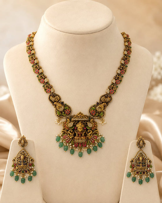 FeelOri ruby and emerald necklace set with matching earrings on jewellery display