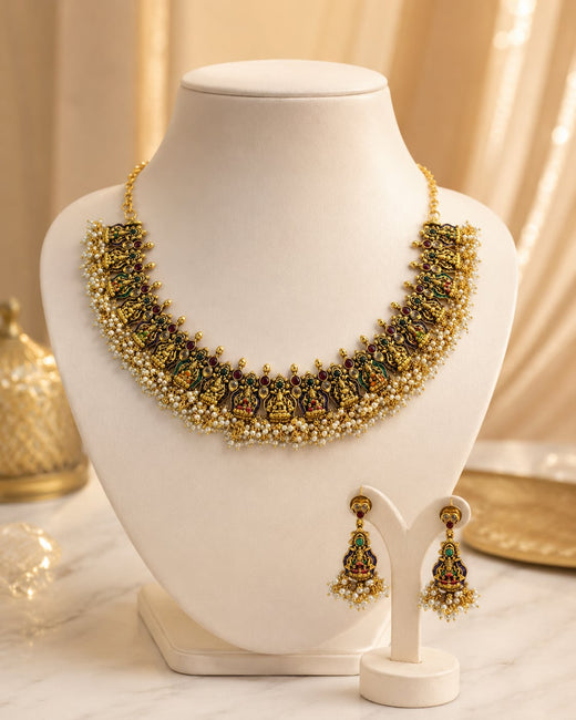 FeelOri ruby and emerald necklace set with matching earrings on jewellery display