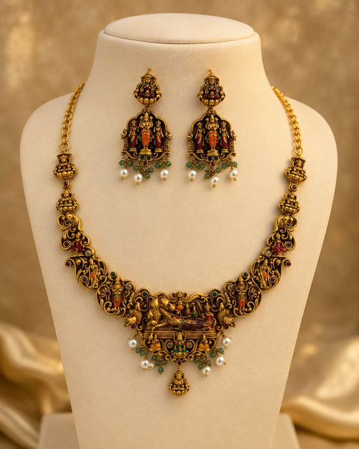 FeelOri ruby and emerald necklace set with matching earrings on jewellery display