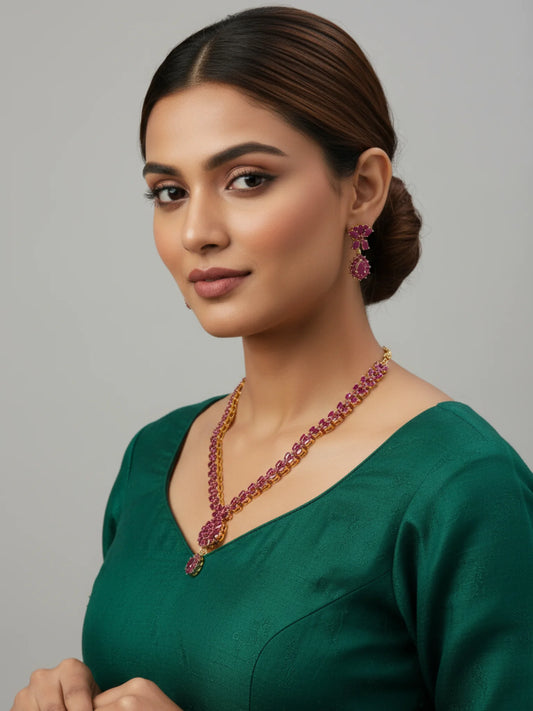 FeelOri Gold Plated Ruby Necklace Set - Model wearing festive ruby studded necklace and earrings with a green top.
