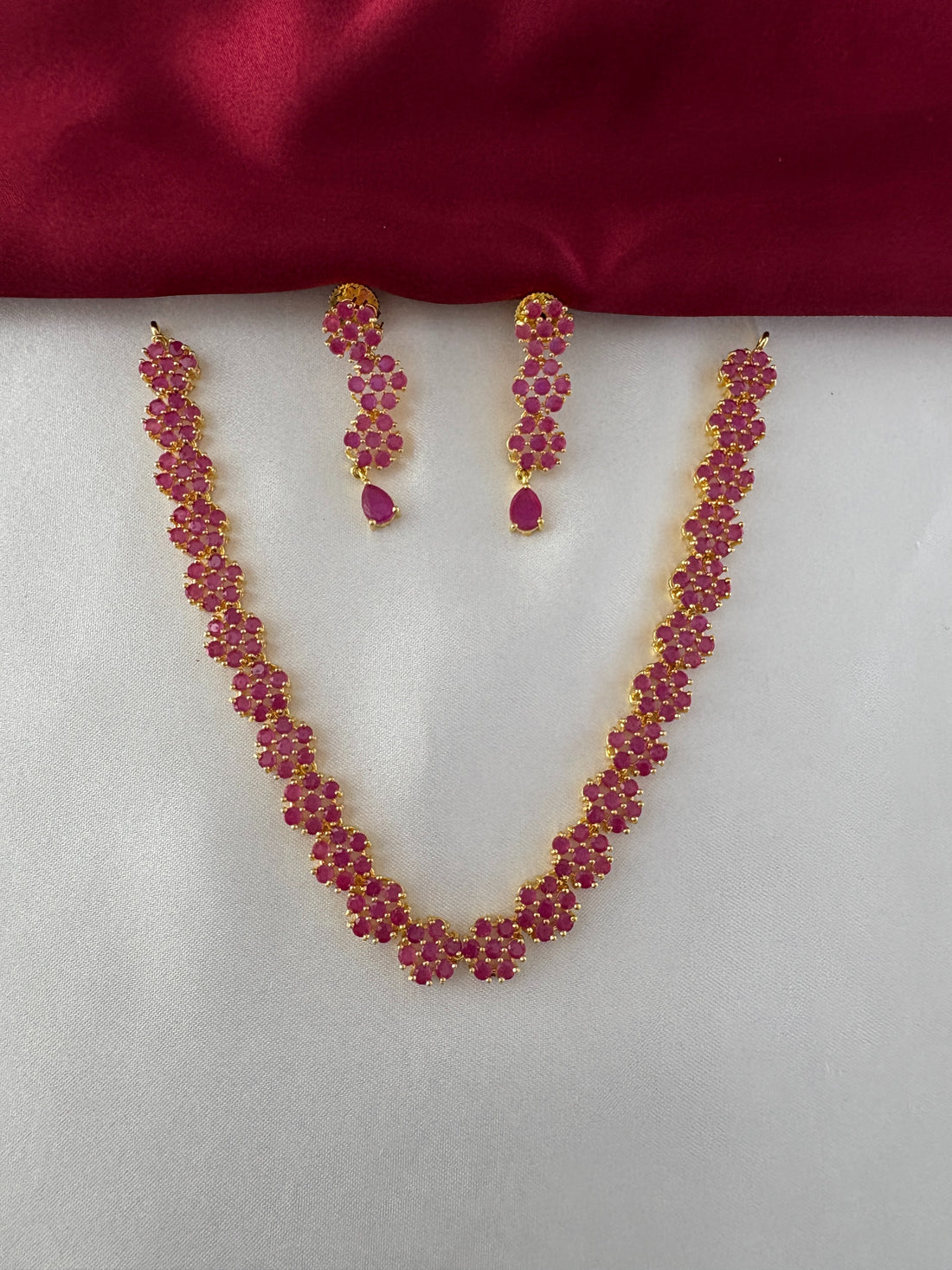 FeelOri Gold Plated Ruby Floral Strand Jewelry Set - Front view showcasing the complete necklace and matching earrings with delicate ruby flower clusters.