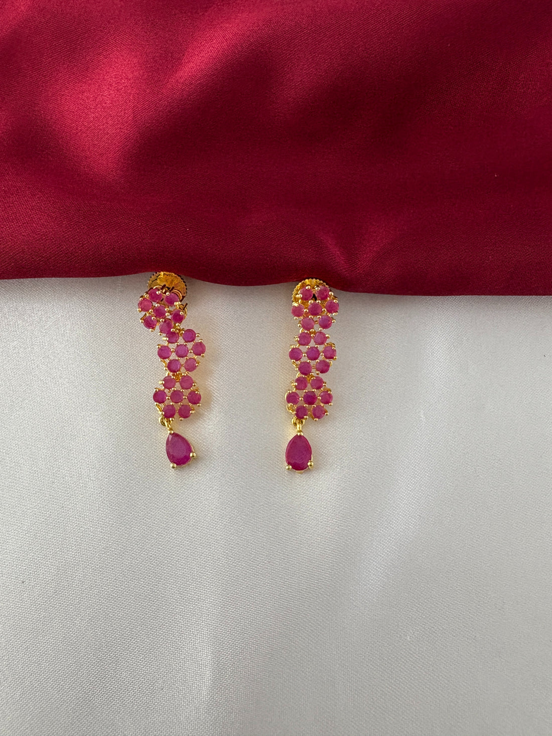 FeelOri Gold Plated Ruby Floral Strand Earrings - Detailed view of the matching earrings, highlighting the three ruby flower clusters and teardrop ruby accent.