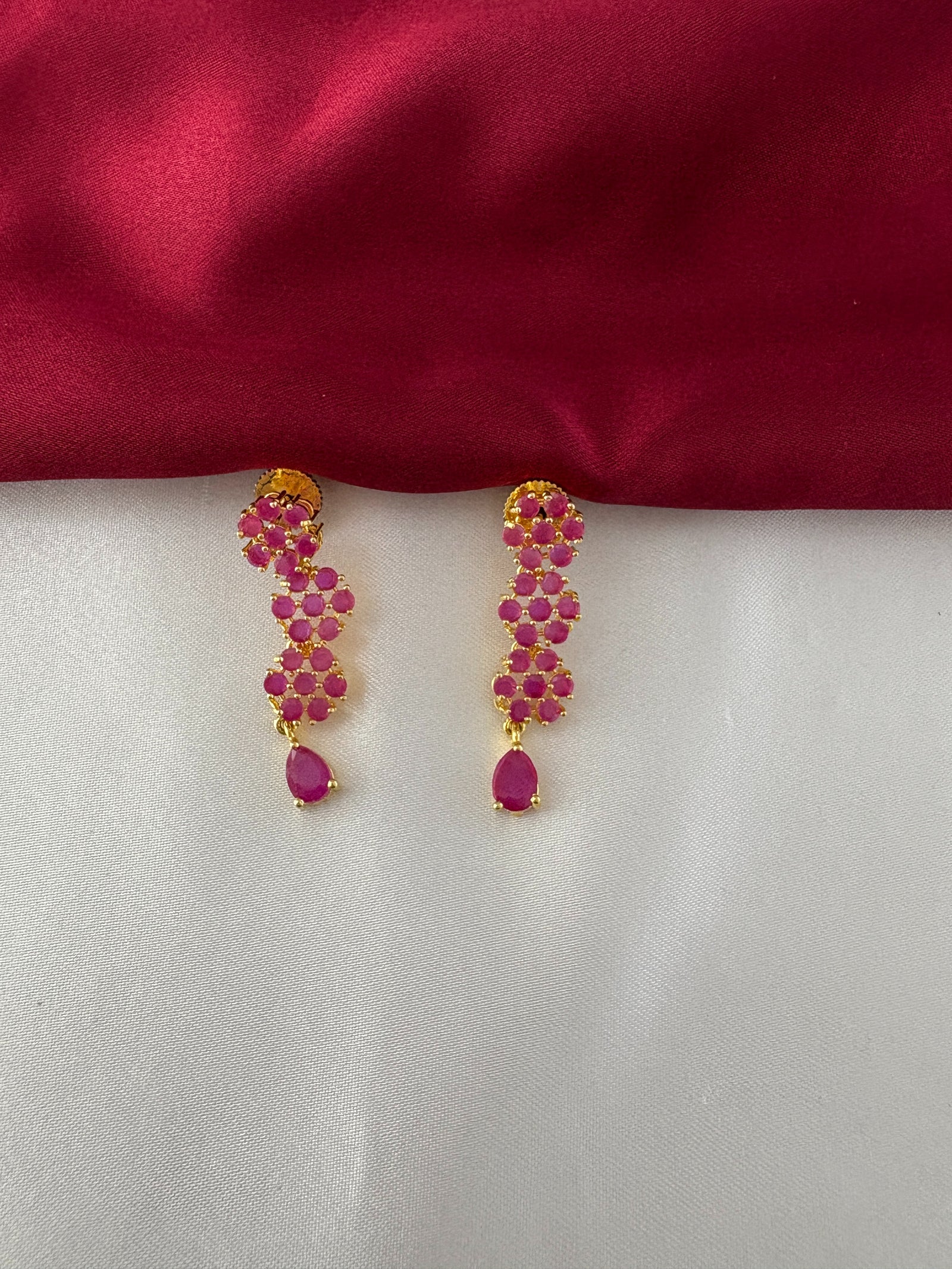 FeelOri Gold Plated Ruby Floral Strand Earrings - Detailed view of the matching earrings, highlighting the three ruby flower clusters and teardrop ruby accent.