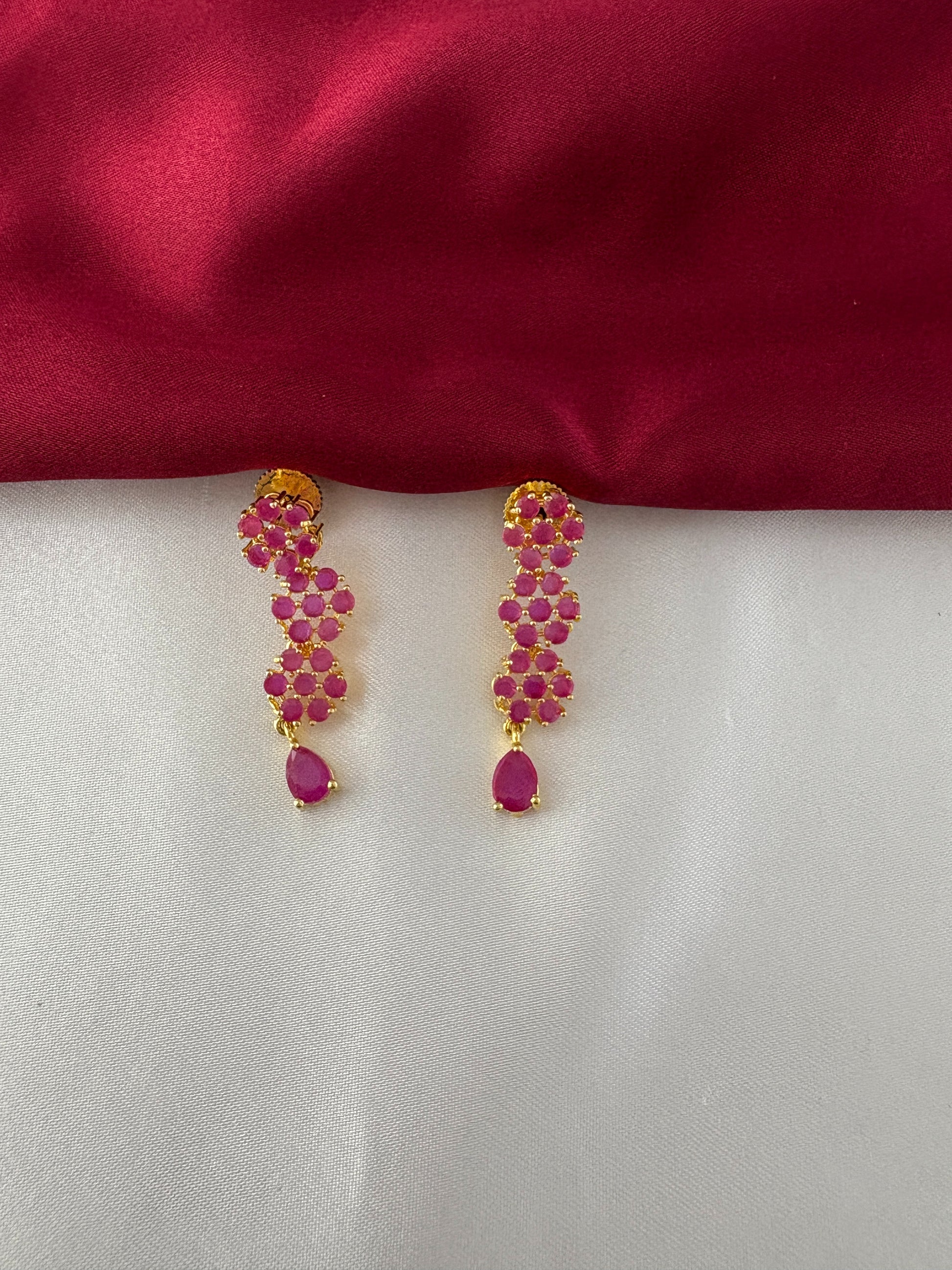 FeelOri Gold Plated Ruby Floral Strand Earrings - Detailed view of the matching earrings, highlighting the three ruby flower clusters and teardrop ruby accent.