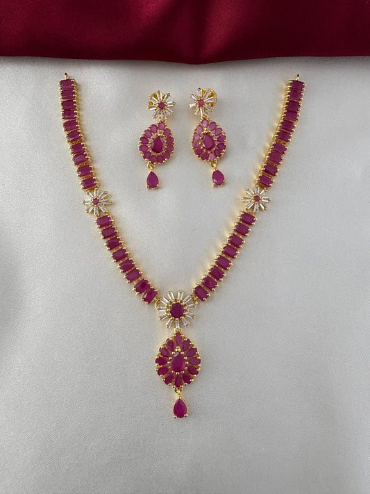 FeelOri Gold Plated Ruby Floral Cluster Necklace Set - Front view showcasing intricate necklace design with matching earrings on a white and maroon backdrop.