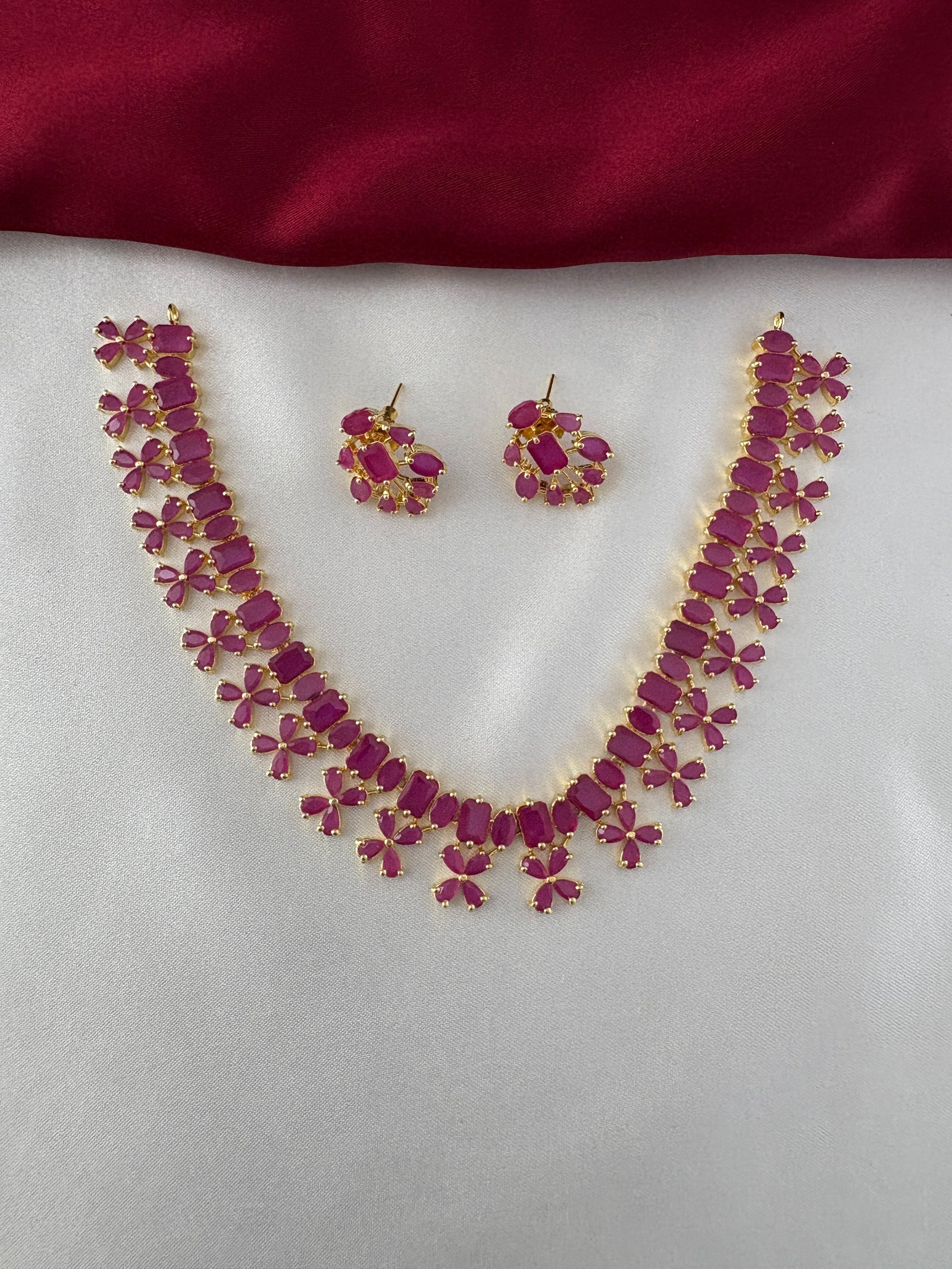 FeelOri Gold Plated Ruby Petal Necklace Set - Front view showcasing the full necklace and matching earrings with their unique stone arrangements.
