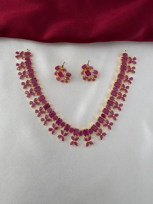 FeelOri Gold Plated Ruby Petal Necklace Set - Front view showcasing the full necklace and matching earrings with their unique stone arrangements.